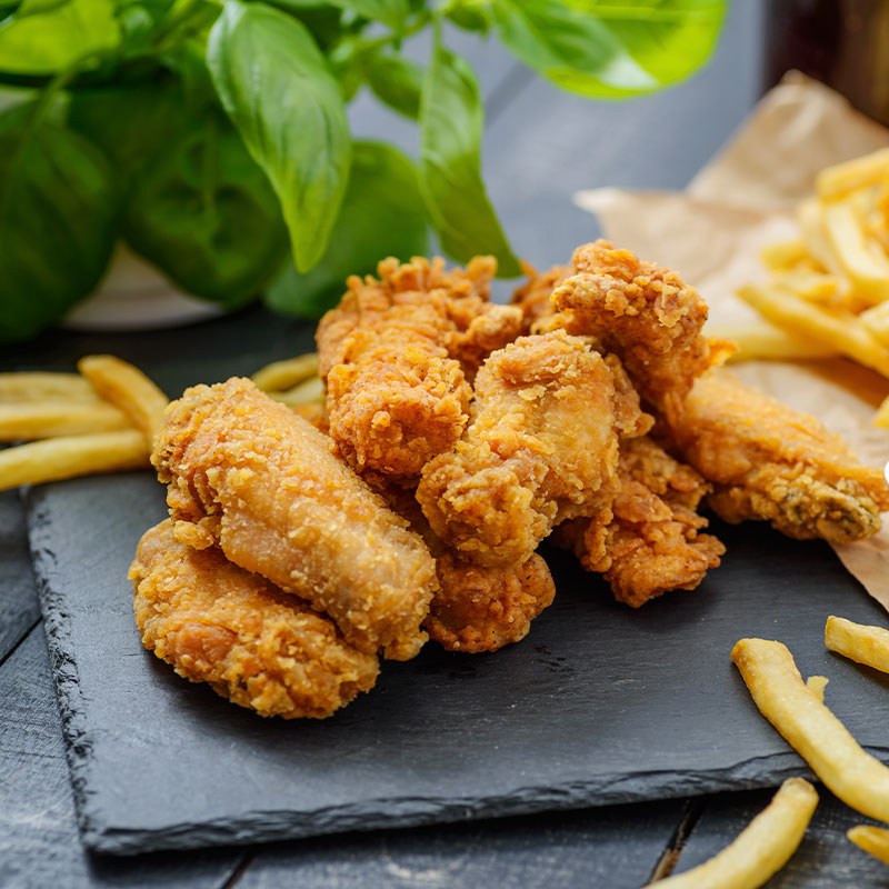 Frozen Fried Chicken Bone In on Slate with French Fries and Basil
